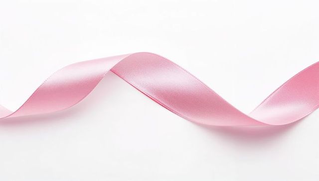 Soft Pink Satin Ribbon Waving Across White Background