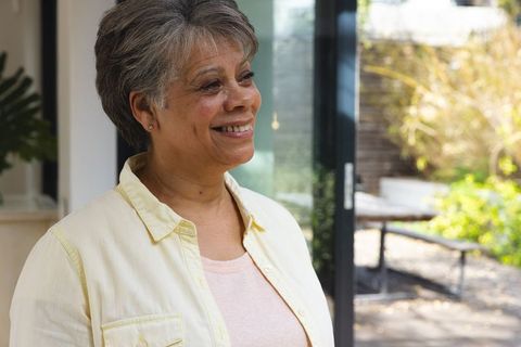 Senior Woman Relaxing by Sliding Glass Door with Natural Light