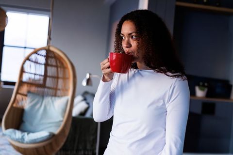 Thoughtful Woman Enjoying Morning Coffee in Cozy Home