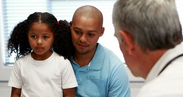 Father and Daughter Receiving Medical Consultation in Clinic - Download Free Stock Images Pikwizard.com