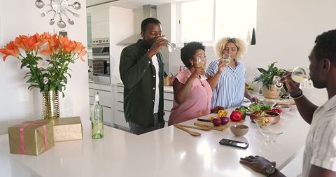 Friends Enjoying Refreshments in Modern Kitchen