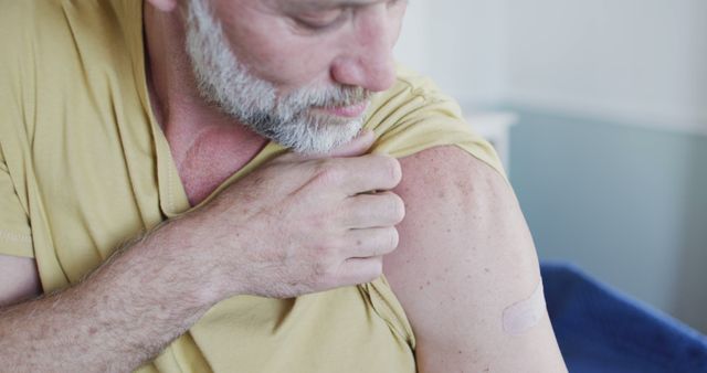 Senior Man Examining Arm After Receiving a Vaccine Injection - Download Free Stock Images Pikwizard.com