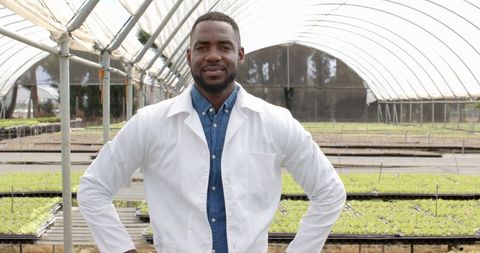 Agricultural scientist in hydroponic farm, smiling and confident outdoors