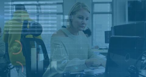 Businesswoman Analyzing Digital Graphs on Computer in Modern Office