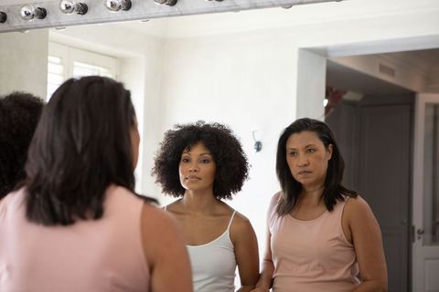 Mother and Daughter Bonding in Front of Vanity Mirror