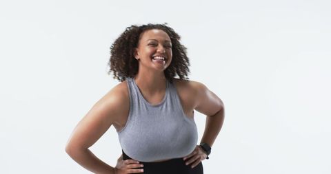Confident Curly-Haired Plus-Size Woman Flexing Arms