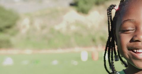 Smiling African American Girl Outdoors in Sunny Park