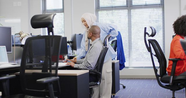 Diverse Office Team Collaborating on Project at Workstation - Download Free Stock Photos Pikwizard.com