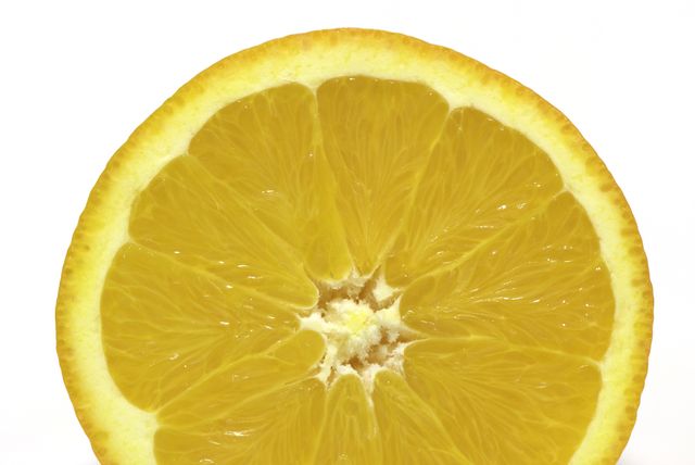 Closeup view of a fresh orange slice showing detailed texture and vibrant colors. Perfect for use in culinary blogs, nutrition articles, and advertisements for fresh produce. Ideal for illustrating concepts of health, freshness, and natural ingredients.
