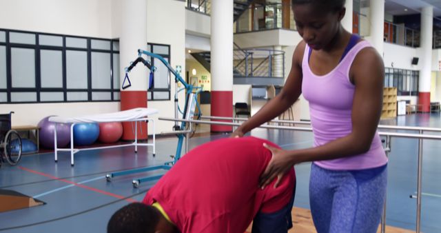 Female Physical Therapist Assisting Male Patient in Rehabilitation Center - Download Free Stock Images Pikwizard.com