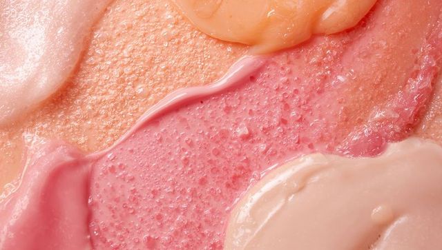 Pastel cosmetic creams blending macro texture with dewy gloss and viscous swatches