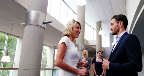 Business Professionals Discussing in a Modern Office Lobby - Download Free Stock Images Pikwizard.com