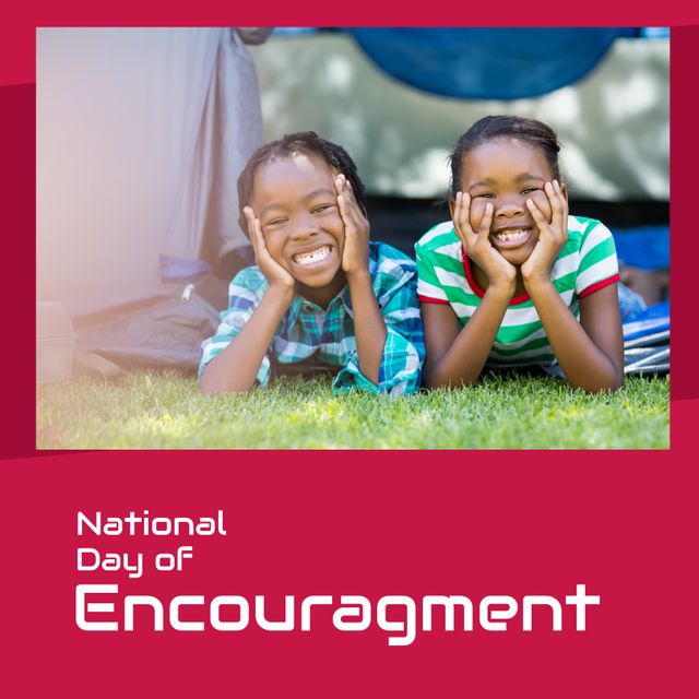 This photo depicts two African American siblings, a boy and a girl, joyfully lying on the grass with their hands on their chins. They are celebrating the National Day of Encouragement with big smiles. The image can be used for promotional materials, social media campaigns, blog posts, and educational flyers aiming to spread positivity, promote sibling relationships, family bonding, and encouragement. Ideal for themes centered around family support, positive messaging, and outdoor activities.