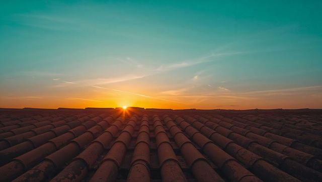 Sunrise over terracotta tiled roof creating warm morning glow