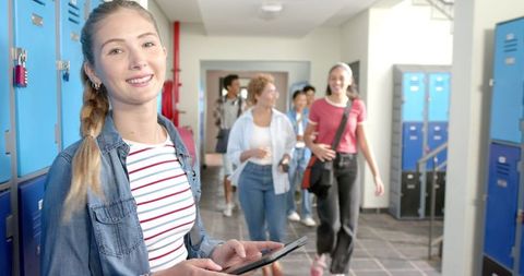 Teenage Girl Using Tablet in High School Hallway by Lockers - Download Free Stock Images Pikwizard.com