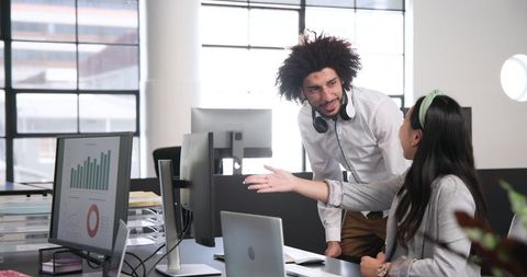 Collaborative colleagues discussing work in modern office