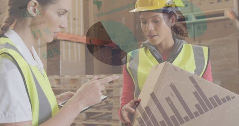 Women collaborating in warehouse using tablet with logistics data overlay