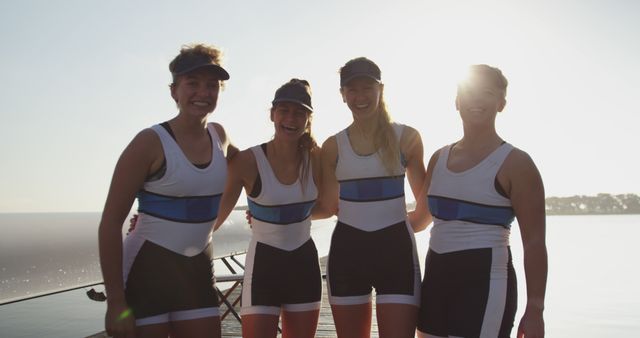 Four female rowers standing together smiling on a sunny day - Download Free Stock Images Pikwizard.com