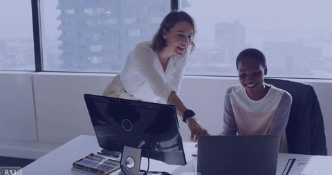 Colleagues Collaborating at Laptop in Modern Office Pointing Coaching with City View
