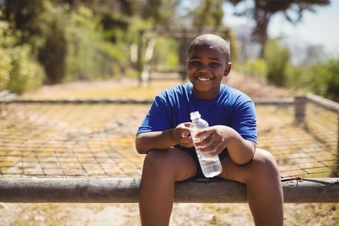Smiling Boy Enjoying Break at Obstacle Course