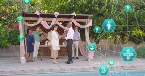Exchanging vows poolside under draped pergola with virtual health network icons