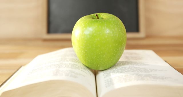 Green Apple on Open Book in Classroom Environment - Download Free Stock Images Pikwizard.com