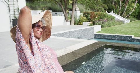 Senior Woman Relaxing Poolside Wearing Sunhat and Sunglasses - Download Free Stock Images Pikwizard.com