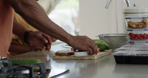 African american men preparing fresh vegetables on modern kitchen countertop for meal prep