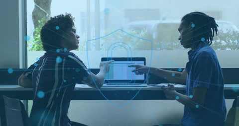 Collaborative Team Discussing Cybersecurity on Computer