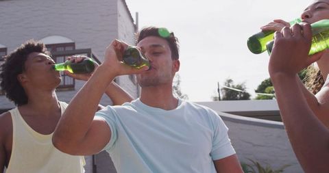 Diverse Group Enjoying Beverages at Backyard Gathering