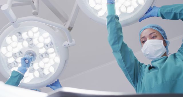 Surgeon Adjusting Operating Room Lights During Surgery - Download Free Stock Images Pikwizard.com