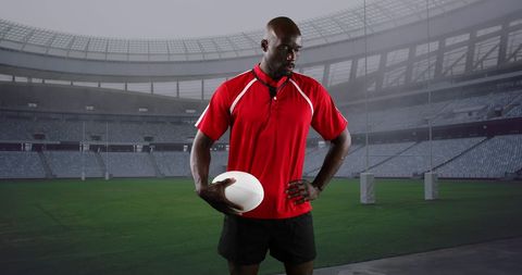 African American Rugby Player Holding Ball in Stadium
