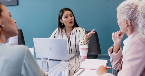Business Meeting with Multiracial Team Collaborating Over Laptop