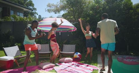 Diverse Friends Dancing at Vibrant Poolside Party Outdoors
