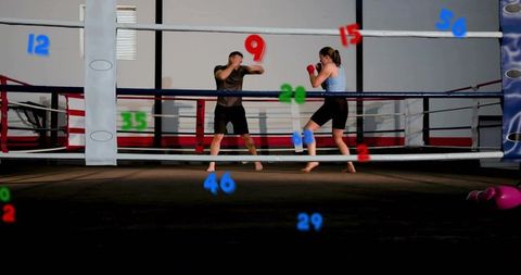 Boxing sparring session in ring with male coach and female boxer training with red gloves