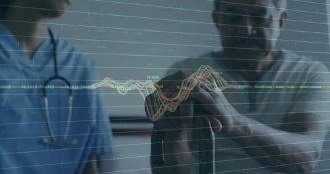 Medical professional advising senior in healthcare clinic with digital assessment