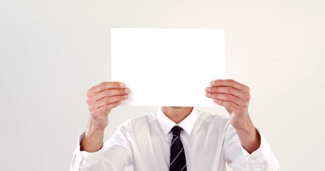 Businessman Holding Blank Sheet of Paper Presenting Message - Download Free Stock Images Pikwizard.com