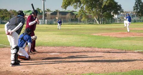 Amateur baseball game at local park featuring diverse players