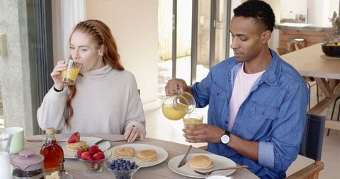 Multiracial Couple Enjoying Breakfast with Pancakes