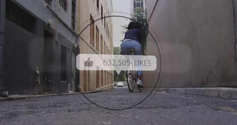 African American Woman Riding Bicycle Exploring Urban Alley