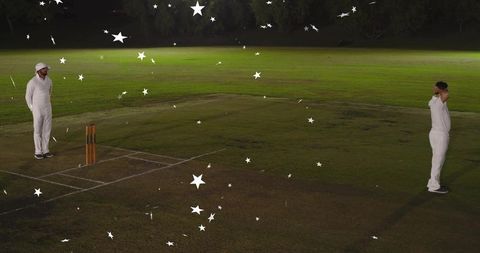 Night cricket duel: two players facing off at stumps on lit outfield with star overlays