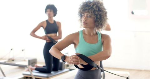 Diverse women practicing yoga together in bright studio environment