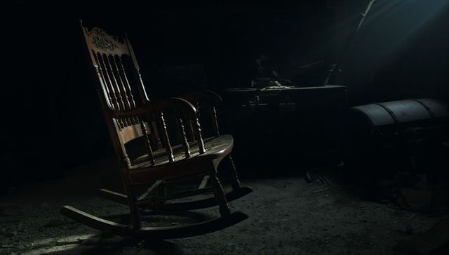 Vintage Wooden Rocking Chair in Dusty Attic with Trunks