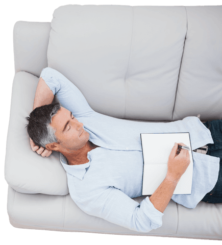Mature Man Relaxing on Sofa with Notebook and Pen - Download Free Stock Videos Pikwizard.com
