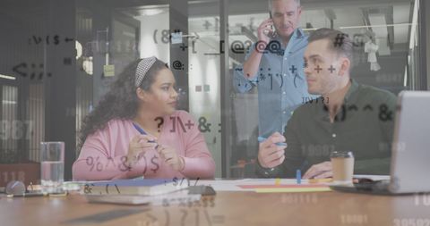 Diverse Team Collaborating on Data Analysis Projects in Office