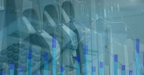 Close-Up of Petrol Nozzles Overlaying Financial Charts and Calculator