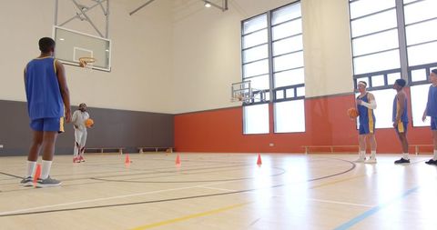 Basketball team coaching: athletes practicing passing drills
