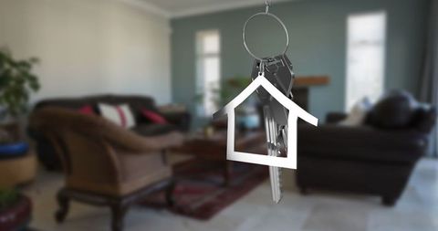 Hanging keyring with house pendant in cozy living room