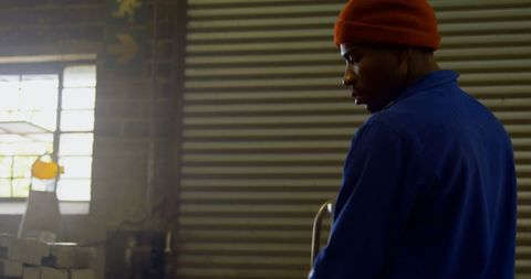 Industrial Worker Using Blow Torch in Metal Workshop