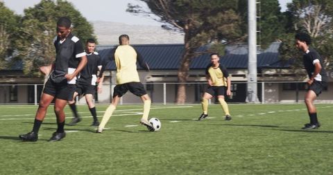 Soccer players in action on field during training session